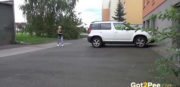  Blonde Pissing Next To A Parked Car